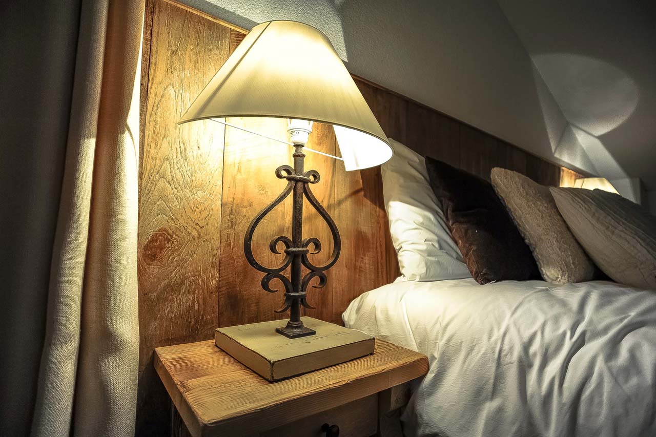 Chalet Le Torrent in Crans Montana bedside table with lamp