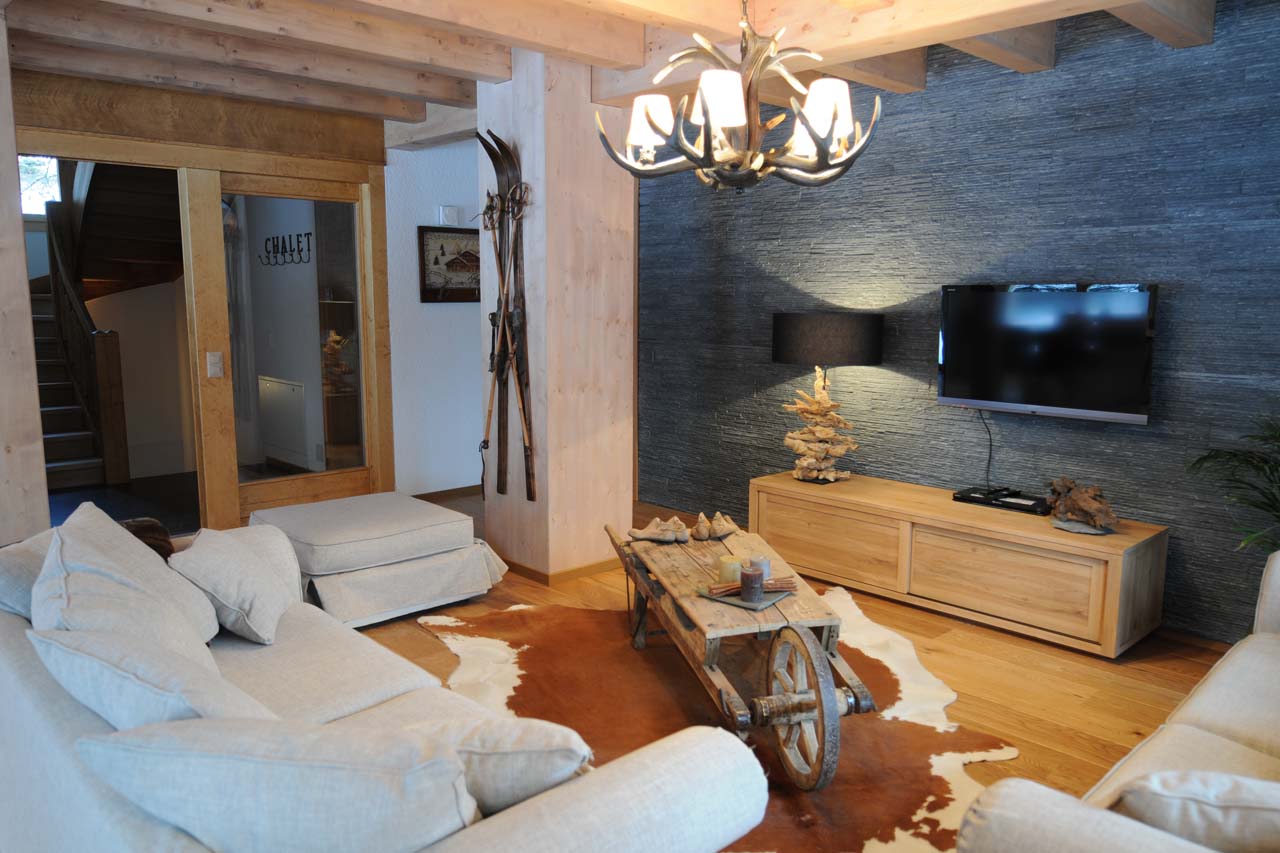 Chalet Le Torrent in Crans Montana living area with sofas and TV